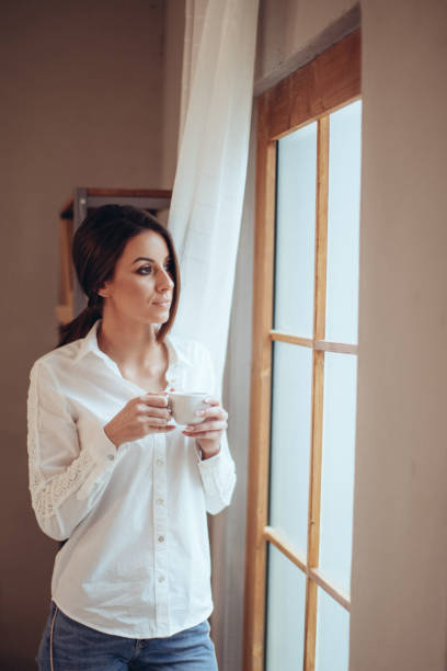 istock Young woman with a cup of coffee 931658420