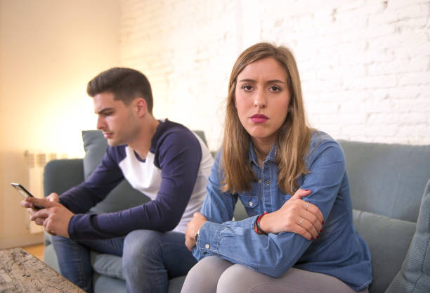 istock young attractive couple in relationship problem with internet mobile phone addiction boyfriend ignoring sad neglected and worried girlfriend at home couch feeling jealous and worried 931662340