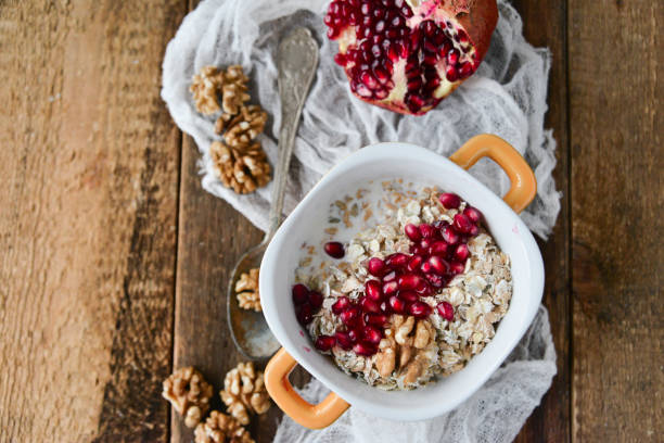 istock Breakfast: granola with pomegranate and walnuts on natural wooden background rustic. The concept of healthy and high-carbon nutrition. 931662614