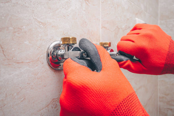 istock Working plumber installs taps on the water heater 931663444