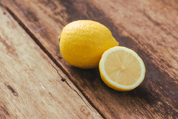 istock Fresh lemons on wooden background. Selective focus. 931666384