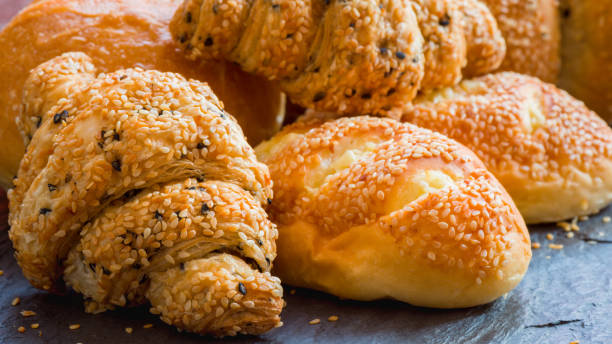 istock Traditional homemade bakery bread with sesame, Stack of fresh bread on table 931669760