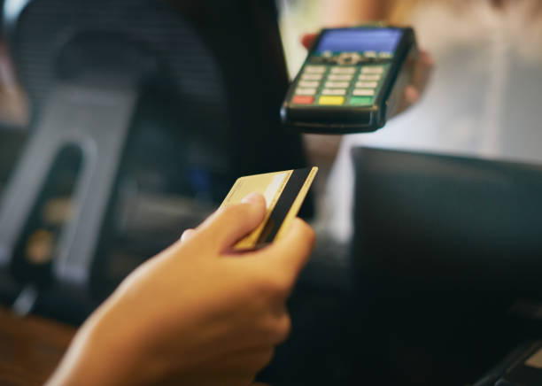 istock Credit card going into hand-held point-of-sale device 931670280