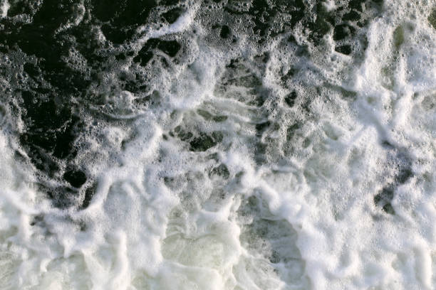 istock stormy creek. wave and foam in the flow. splashes, bubbles, waves, stream, ripples and crests of waves in a fast forest stream in winter 931670362