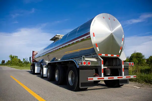 Photo of Silver fuel tanker parked on the road