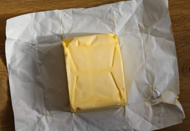 istock pack of dairy butter in kitchen on wooden background 931671886