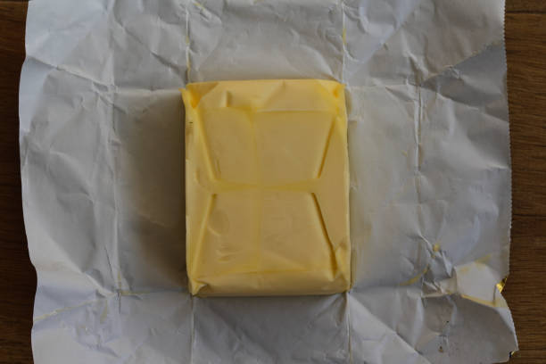 istock pack of dairy butter in kitchen on wooden background 931671890
