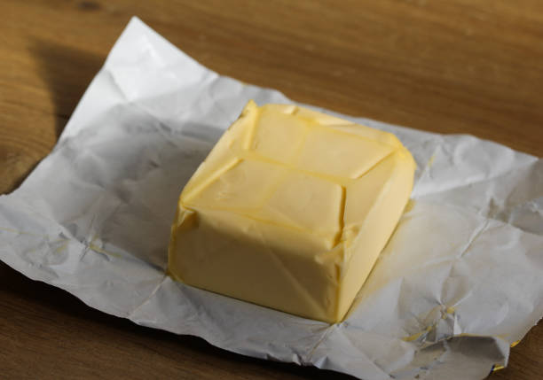 istock pack of dairy butter in kitchen on wooden background 931671932