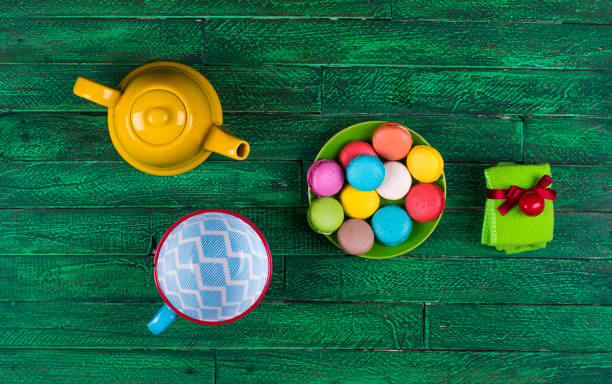istock colorful french macarons ,kettle, wooden table 931681568