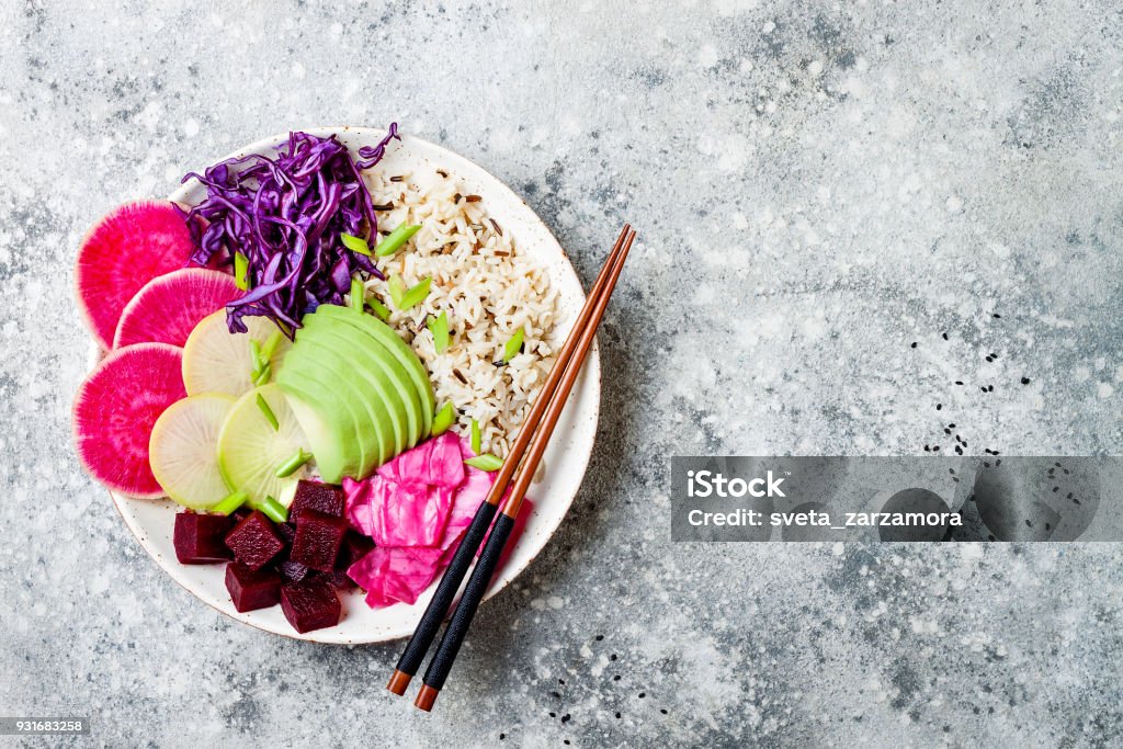 Vegan poke bowl with avocado, beet, pickled cabbage, radishes. Top view, overhead, flat lay Food Stock Photo