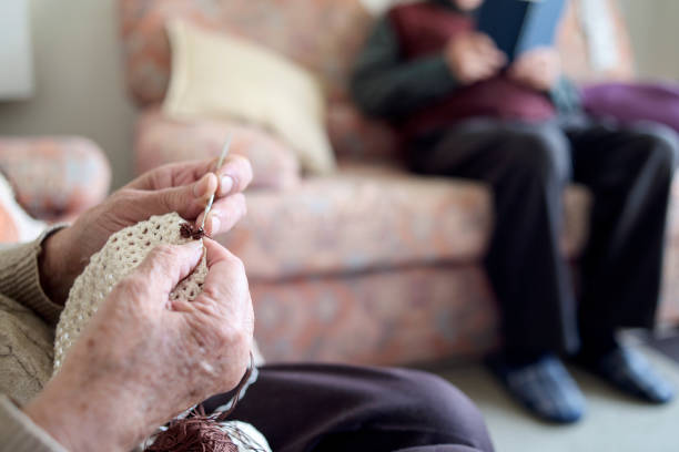 istock old woman crocheting and old men reading a book 931687628