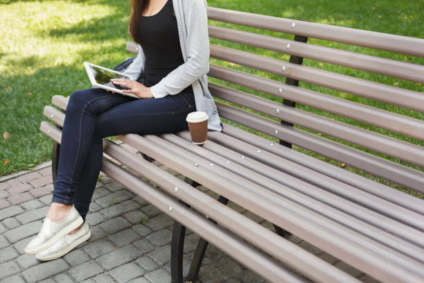 istock Unrecognizable woman typing on tablet outdoors 931688774