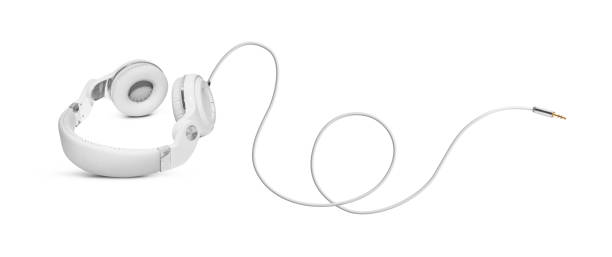 White headphones and Convention Aux cable 3.5 mm White headphones and Convention Aux cable 3.5 mm. Isolated on white background aux cable stock pictures, royalty-free photos & images