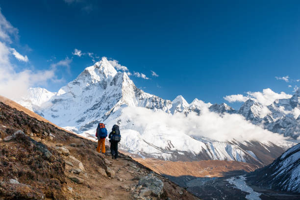 istock Trekkers approaching Amadablan mount in Khumbu valley on a way to Namche Bazar 931693052