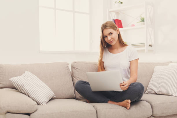 istock Young girl with laptop indoors 931693464