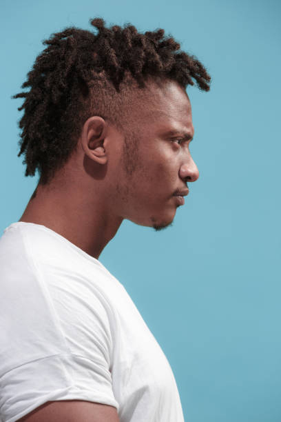 istock The young emotional angry afro man on blue studio background 931696212