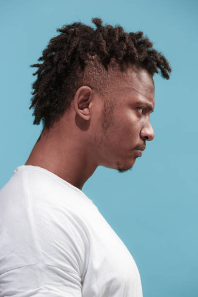 istock The young emotional angry afro man on blue studio background 931696614