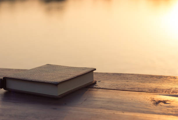 istock Notebook on the wooden Table with bokeh Sunset 931697270