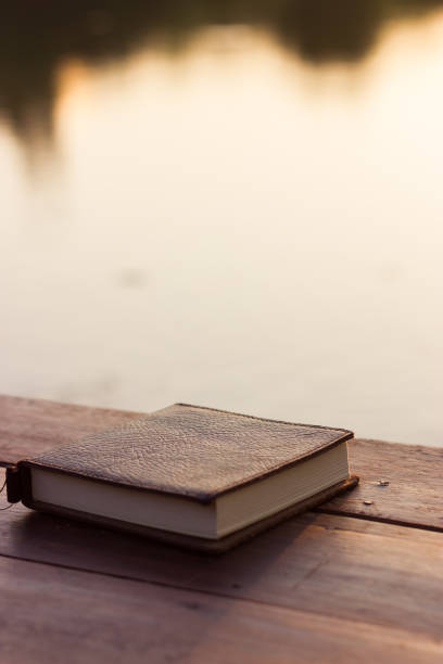 istock Notebook on the wooden Table with bokeh Sunset 931697312