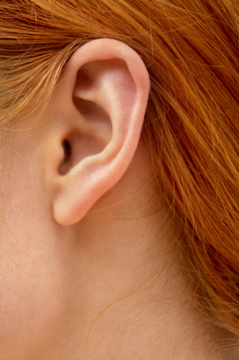 people, hearing, healthcare and plastic surgery concept - close up of female ear 