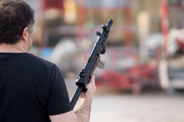 istock Back turned caucasian man holding a sniper rifle 931704014