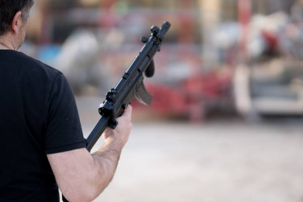 istock Back turned caucasian man holding a sniper rifle 931704040