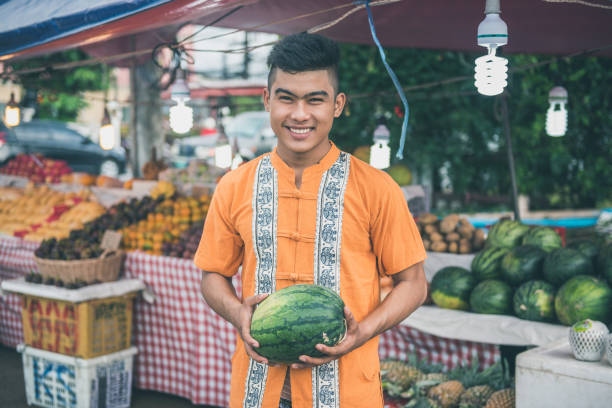 istock Farmer with watermelons on green market 931705130