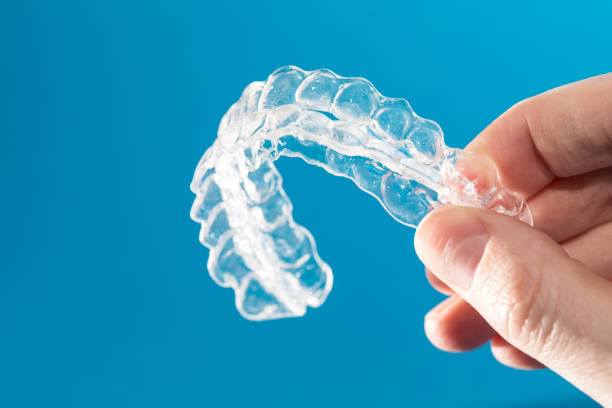 Inivisalign braces or invisible orthodontic aligner. Inivisalign braces or aligner. A way to have a beautiful smile and white teeth. dental equipment hand stock pictures, royalty-free photos & images