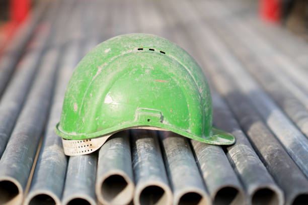 istock Green safety helmet on metal tubes 931705460