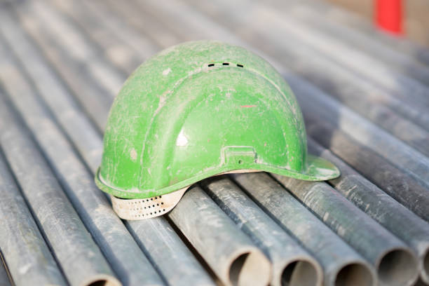 istock Green safety helmet on metal tubes 931705464