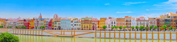 View from the coast of the Guadalquivir to the Triana district in Seville. Seville, Spain - June 08, 2017 : View from the coast of the Guadalquivir to the Triana district in Seville. Spain. seville port stock pictures, royalty-free photos & images