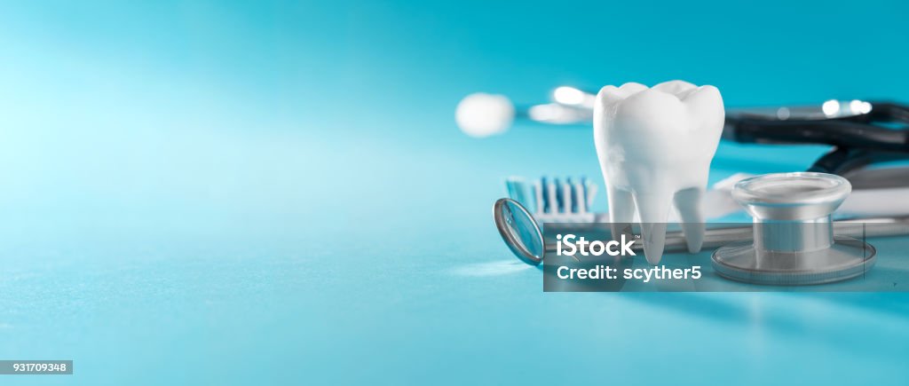 Tooth, health, dentistry concept. White healthy tooth, different tools for dental care. Dental background. Dental Health Stock Photo