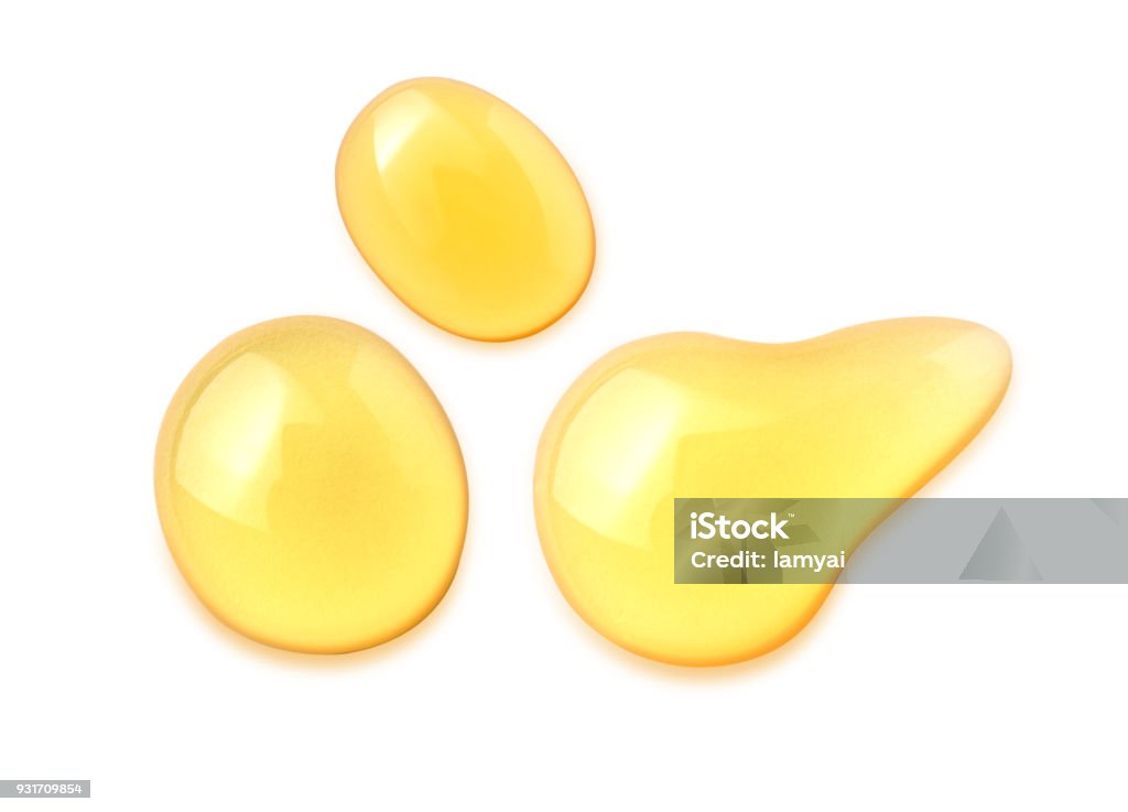 Macro honey drops isolated on white background, File contains a clipping path. Cooking Oil Stock Photo