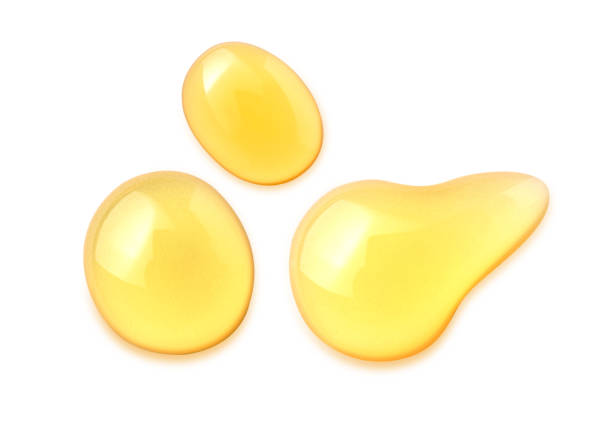 Macro honey drops isolated on white background, File contains a clipping path. Macro honey drops isolated on white background, File contains a clipping path. cooking oil photos stock pictures, royalty-free photos & images