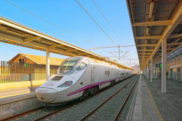 North Railways Station and modern hi-speed passenger train of Spanish railways company - Renfe. Valencia, Spain - June 13, 2017 : North Railways Station (Estacio del Nord) and modern hi-speed passenger train of Spanish railways company - Renfe. seville port stock pictures, royalty-free photos & images