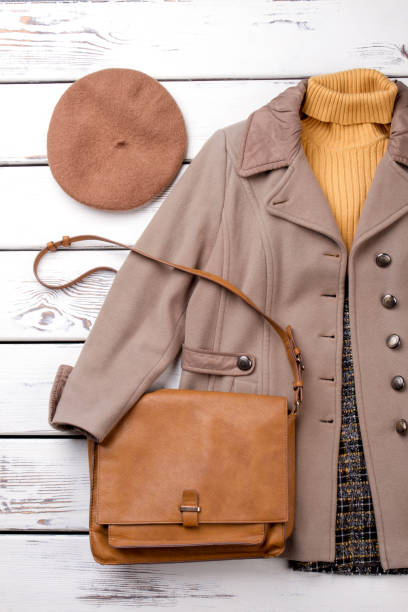 istock Autumn clothes set on wood background. 931716056