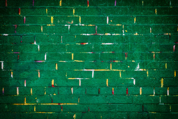 istock Green painted brick wall with yellow lines 931717220