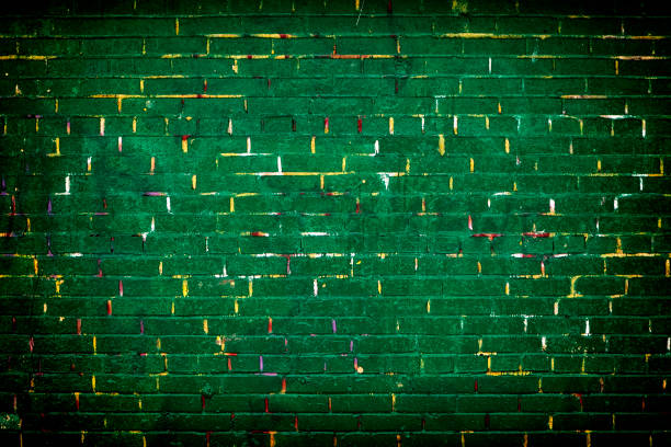 istock Brick wall painted in green color with yellow lines 931720060