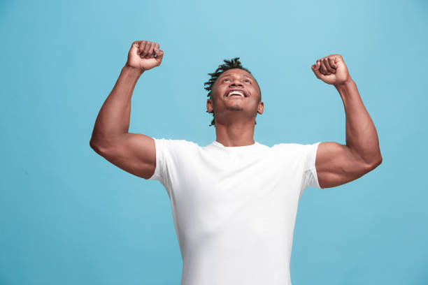 istock Winning success afro-american man happy ecstatic celebrating being a winner. Dynamic energetic image of male model 931721272
