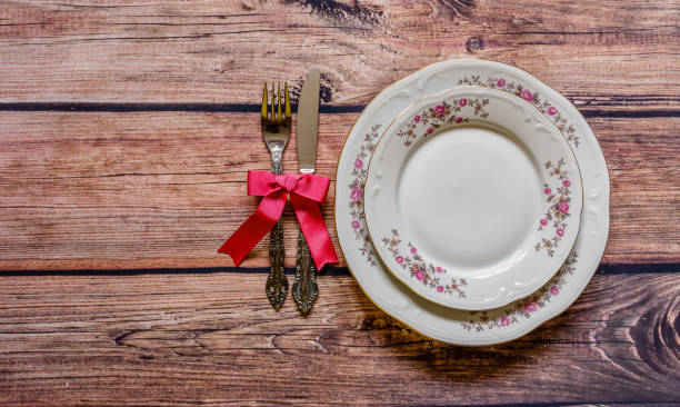 istock Vintage silverware tied with pink bow and chine on rustic wooden background 931721398
