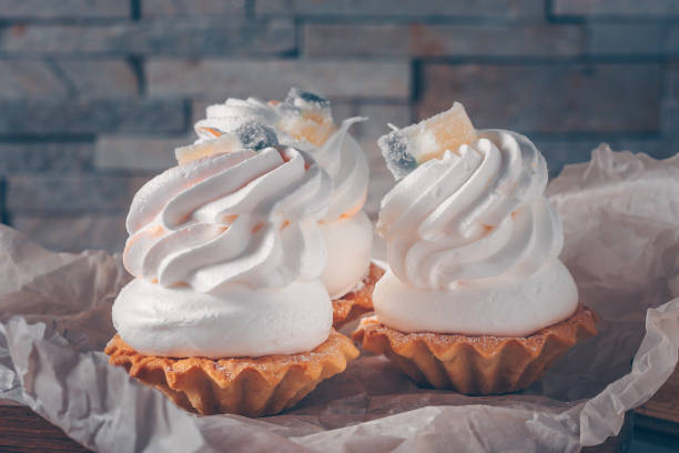 istock Three cakes with white cream on baking paper, selective focus, trend tinting 931723950
