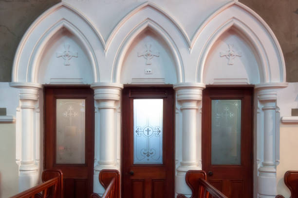istock Church interior confessional booths framed by arches and columns. 931724268