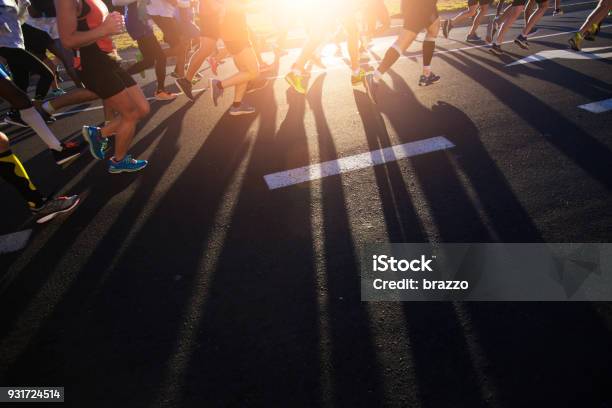 Shadows Of Joggers Legs On The Road Stock Photo - Download Image Now - Marathon, Road Running, Running