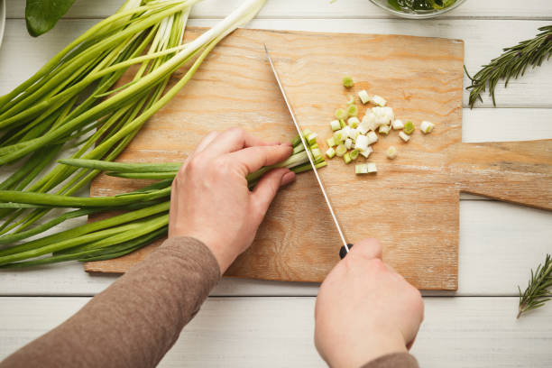 istock Woman cutting spring onion for salad 931724944