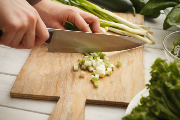 istock Woman cutting spring onion for salad 931725050