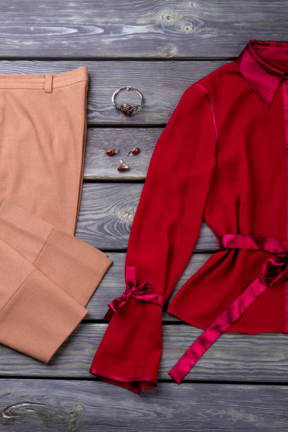 istock Flat lay brown trousers and red blouse. 931725414