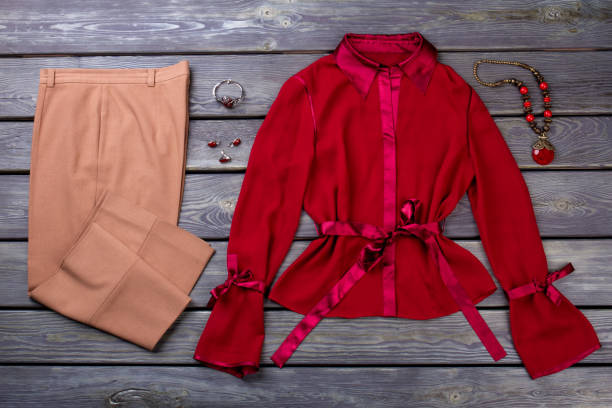istock Women's brown pants and red blouse. 931725416