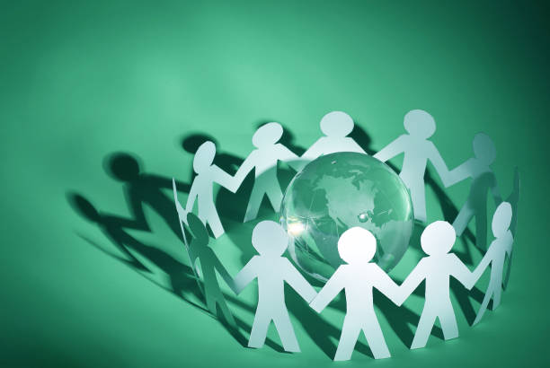 istock group of paper men standing around the glass globe 931725586