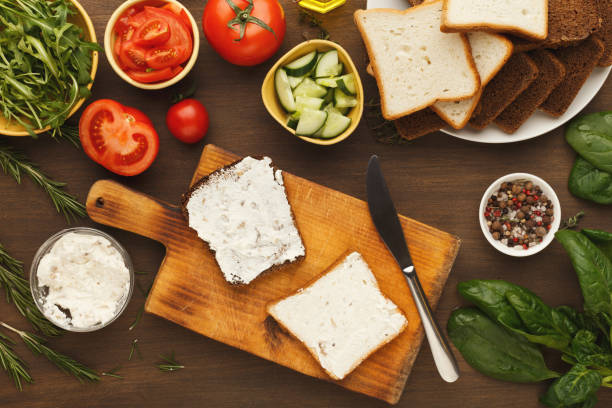 istock Cooking tasty sandwich with cream cheese, top view 931728028