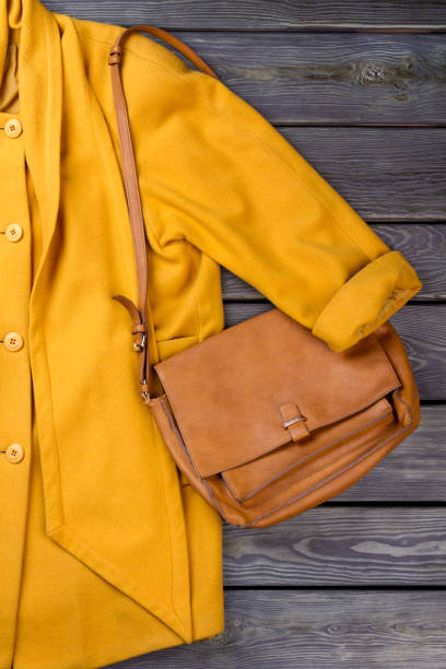 istock Yellow coat and handbag, close up. 931728678